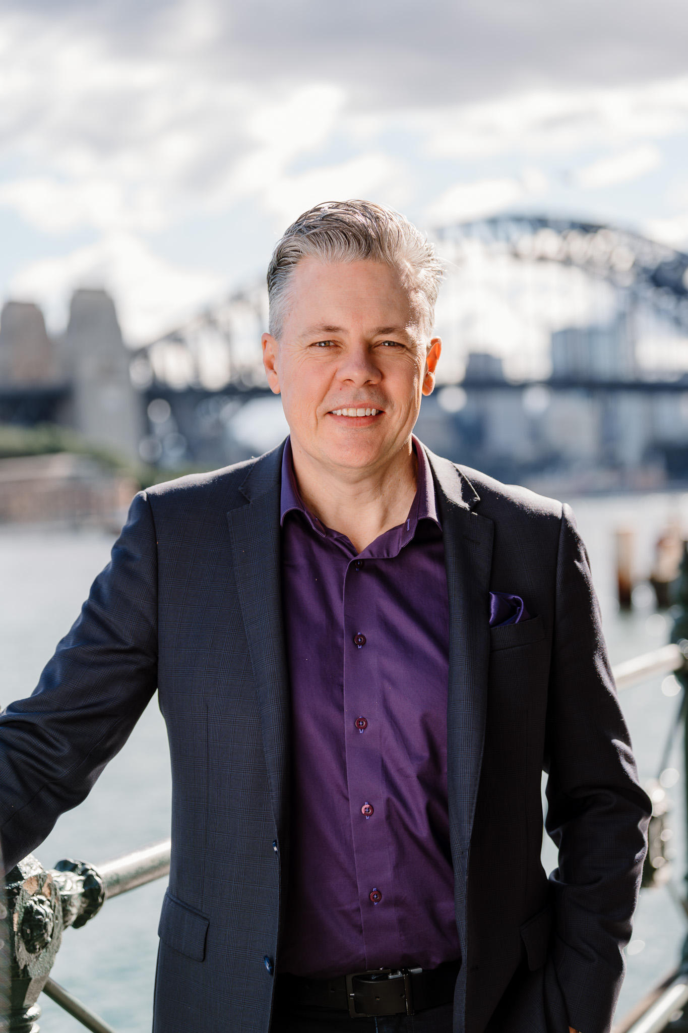 Portrait of Mark Jones CSP on Sydney Harbour with the Harbour Bridge behind him